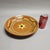 A traditional Westmoore Pottery redware 12” shallow bowl or charger. Hand painted in tones of butter yellow, green, and...