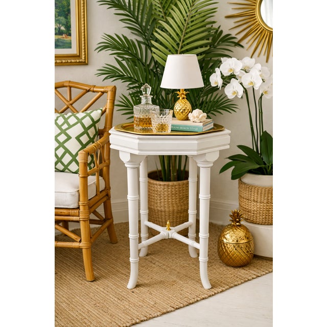 This elegant Hollywood Regency-style pedestal side table features a refined octagonal form and timeless neoclassical...