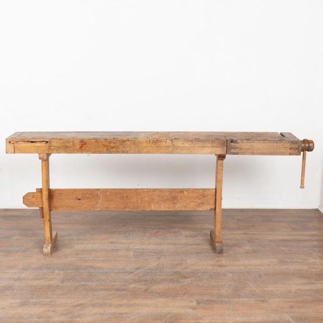 The worn patina of this old carpenter's workbench is a reflection of its age and years of use. Every ding, scratch, deep...