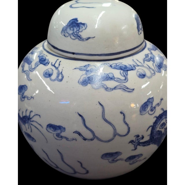 Vintage Hand-Painted Blue and White Dragon Ginger Jar With Matching Lid This charming vintage blue-and-white ginger jar is...