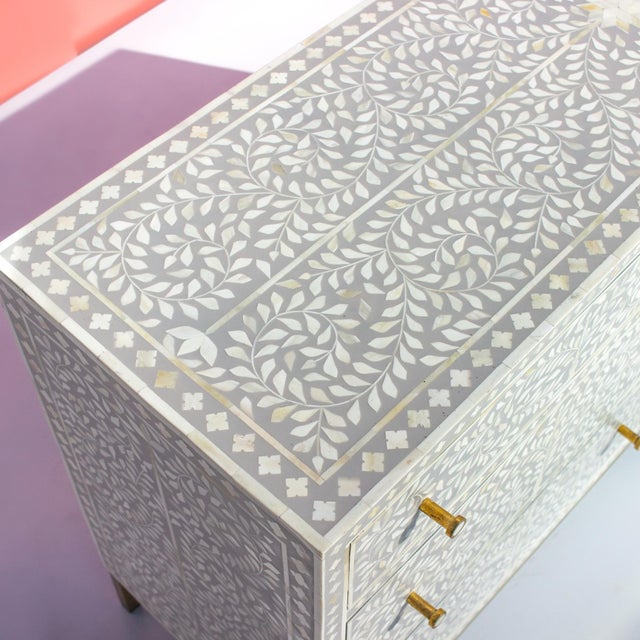 The Arabesque Bone Inlay Six-Drawer Dresser presents a contemporary interpretation of classical botanical ornamentation....
