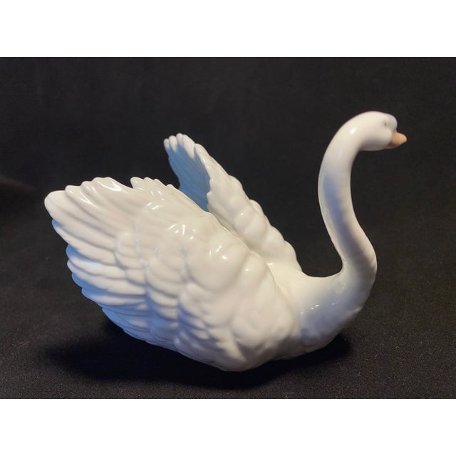Gracefully elegant and beautifully crafted, this **Lladro White Swan Figurine #6175** is a retired collectible that...