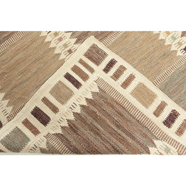 A modern flat-weave area rug, being a typical representative of the timeless Swedish school of design. It is woven...