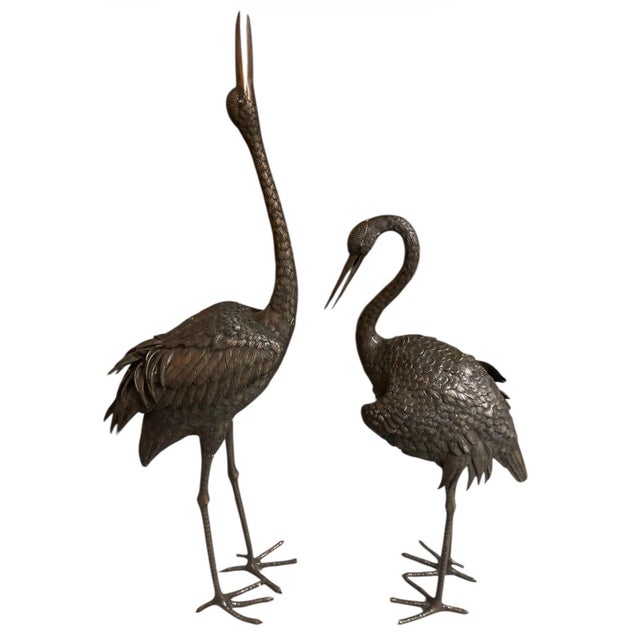 These elegant bronze crane sculptures, likely dating from the late 19th-century Meiji period or early 20th century,...