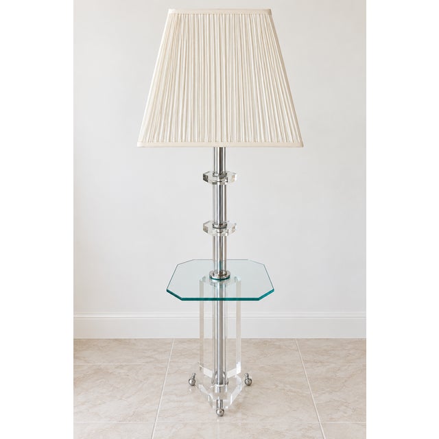 Striking vintage floor lamp featuring a clear lucite/acrylic body with polished chrome accents and an integrated glass...