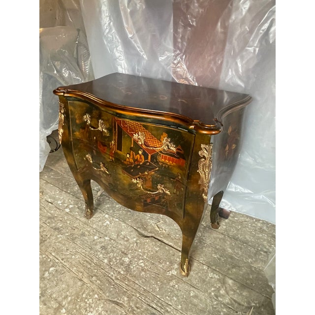 A small size Louis XV style bombe chest decorated in Chinoiserie style lacquer by Maitland- Smith furniture. The chest is...