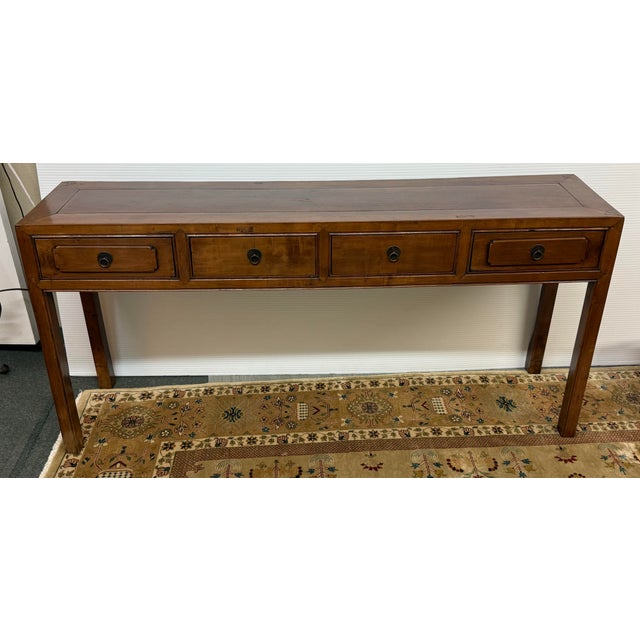 Design Plus Gallery presents an Antique Asian Console Table. This 20th century solid wood console exhibits Ming-style...