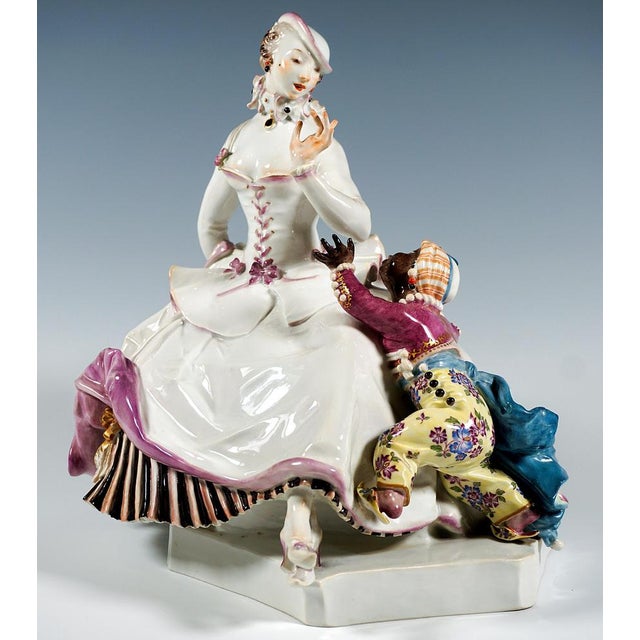 Finest meissen porcelain figurine group: seated crinoline lady in an elaborate costume: under the wide skirt, partially...
