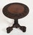 A round highly carved Burmese table on a tri formed base Circa 1840 Legs terminating in mythical Asian characters....
