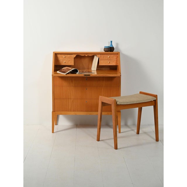 Scandinavian 1950s elm secretary with drop-leaf top. Interior features a pair of drawers and a shaped burl wood shelf....