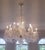 This chandelier is a grand, multi‑tier crystal fixture featuring an ornate, symmetrical design built around a sculpted...