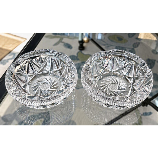 A striking, matched pair of vintage heavy cut crystal catchalls. Featuring a classic, deeply cut Bohemian pinwheel and...
