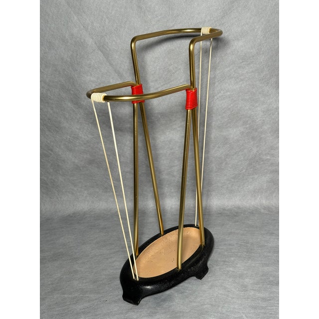 Umbrella stand made of brass-plated aluminum with a cast iron base. European production from the 1960s. Freestanding...
