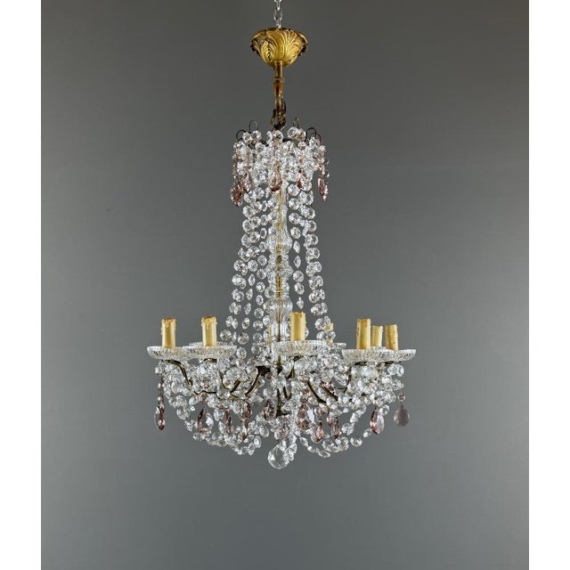 Elegant Louis XV style chandelier with cut crystal pendants, richly adorned with garlands, drops, and crystal elements....