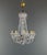 Elegant Louis XV style chandelier with cut crystal pendants, richly adorned with garlands, drops, and crystal elements....
