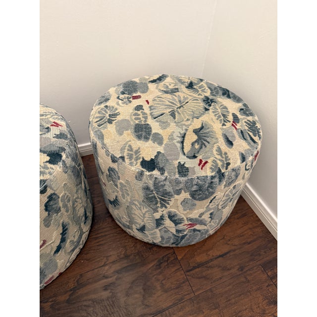 Gorgeous pair of custom round ottomans upholstered in Scalamandre Ninfee fabric in Grigio Azzurro colorway. Fabric runs...