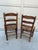 This is a remarkable pair of antique American ladder-back side chairs, dating back to the 19th century. Crafted from rich,...