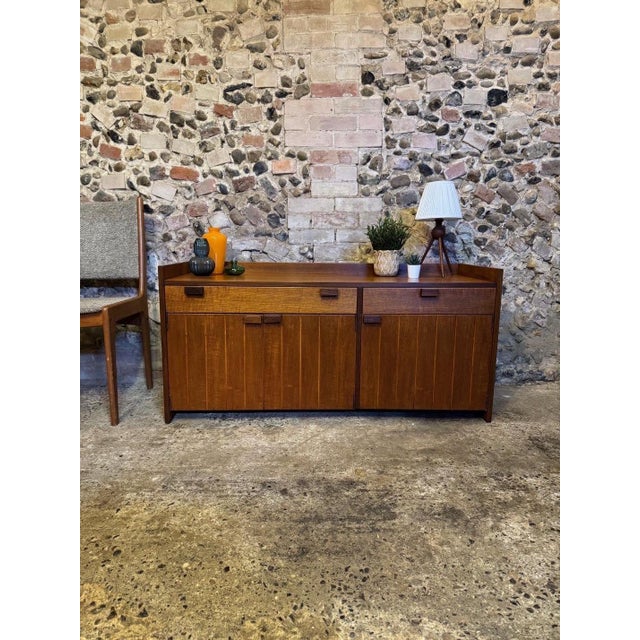 Fantastic example of a rare brutalist teak sideboard by Meredew, England. The sideboard is crafted from wonderful teak...