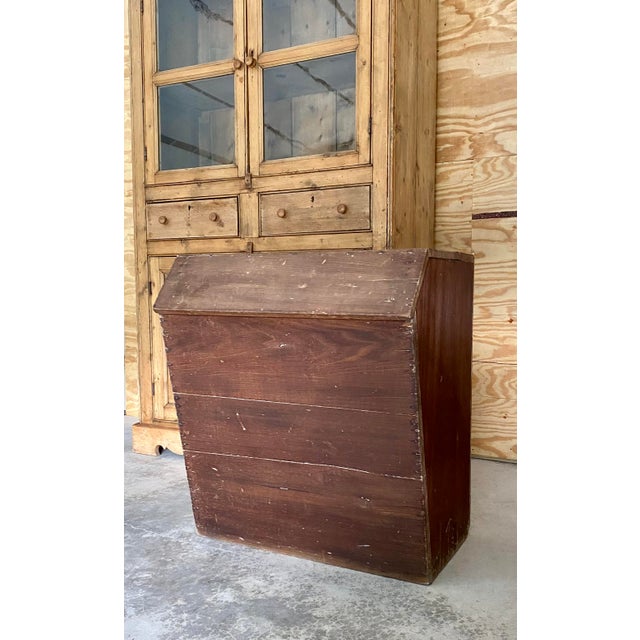 Primitive wood bin console of solid wood planks. Angled profile and interior storage space make this piece unique. This...