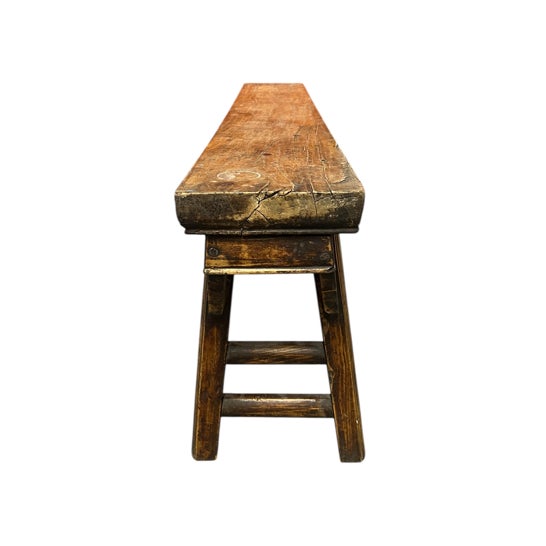 This Chinese narrow altar bench appears to be made of elm or another hardwood, handmade in the late 19th to early 20th...
