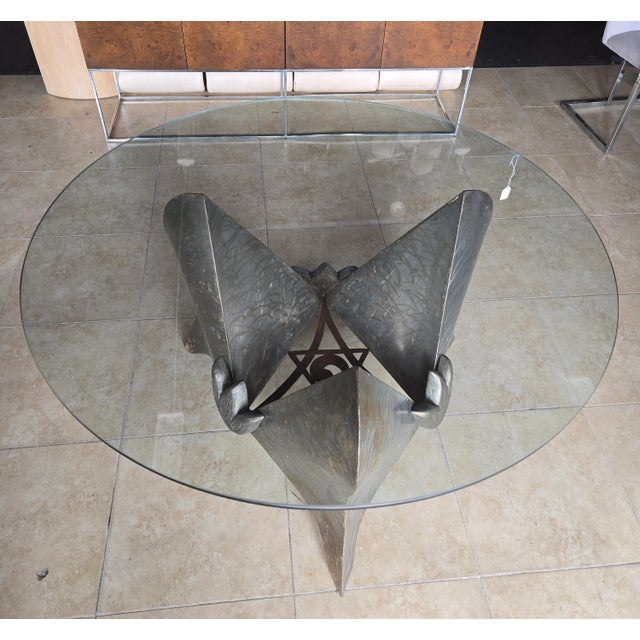 Amazing steel dining table is welded into an abstract 3 point Brutalist style base showing hints of rust and etchings in...