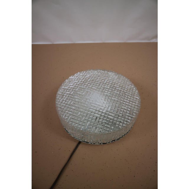 1960s ceiling lamp made by Glashütte Limburg in the 1960s. The relief gives the lamp a beautiful light. This piece has an...