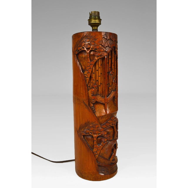 Living room lamp. Carved wood. 2 scenes: at the top, a group in a bamboo forest. Below, a character in a boat. Asia, mid-...