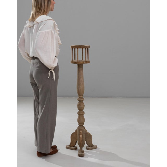 This 1900s French oak pedestal is an elegant and versatile accent piece, showcasing a finely turned central column and...