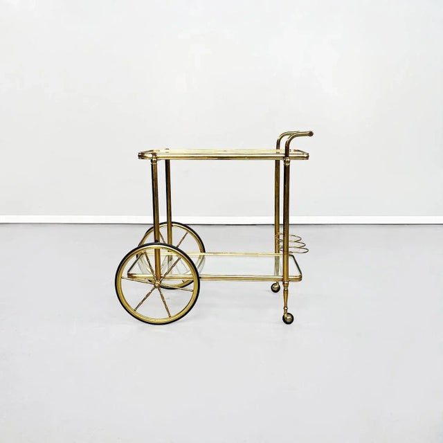 Italian Mid-Century Modern cart in brass and glass, 1950s. Rectangular food trolley with rounded brass corners. The two...