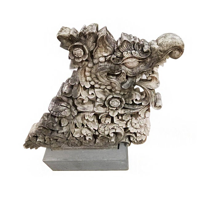 A superb stone sculpture of a dragon and flowers. Indonesia, early 20th Century. Reclaimed from an old building, this...
