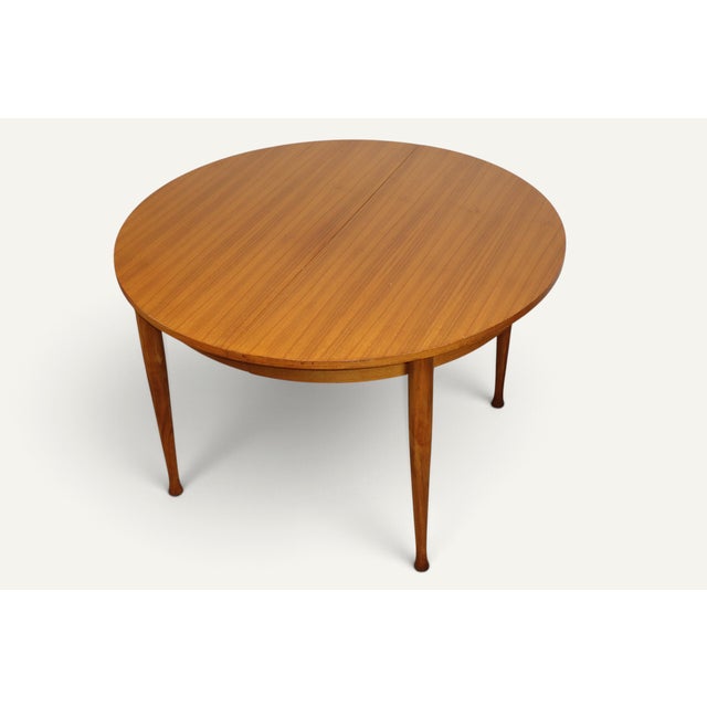 An elegant extendable teak dining table dating from the 1960s, with a simple and balanced design. Its circular top...