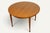 An elegant extendable teak dining table dating from the 1960s, with a simple and balanced design. Its circular top...