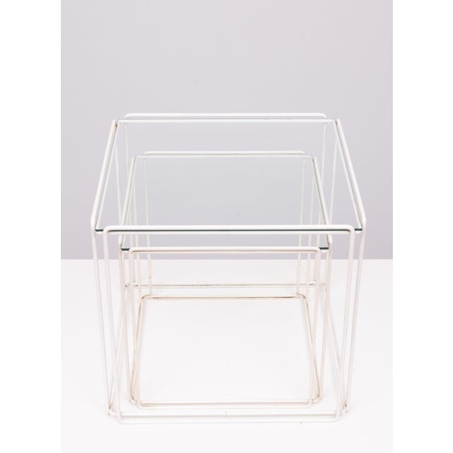 Set of two Max Sauze Isocele side tables made of black steel with clear glass. The tables are in good condition. Minimal...