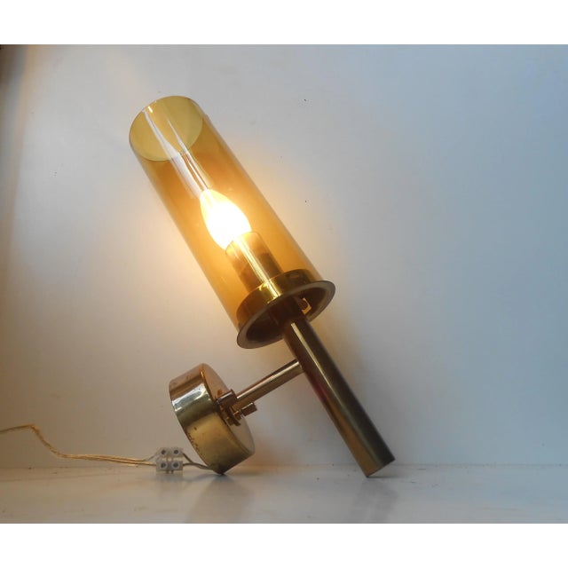 Brass and glass tubular wall sconce designed by Hans-Agne Jakobsson for Markaryd AB, Sweden. This piece has an attribution...