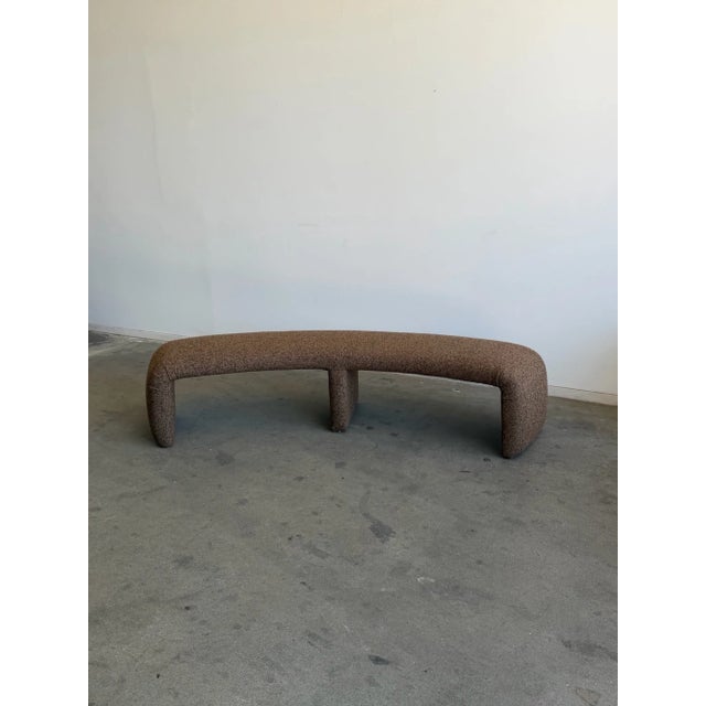 W83 D29 H20 SW80 Handcrafted and made in house. A curved bench in a nubby textured brown fabric. On the firmer side with a...
