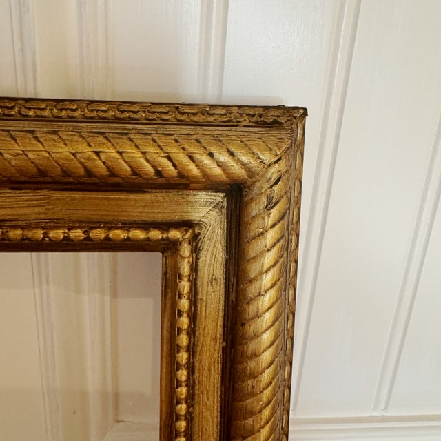 Bring classic charm to your art or photos with this vintage wooden frame, carefully refinished in a warm, antiqued gold....