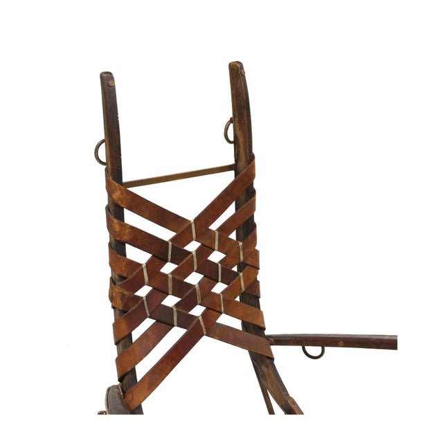 Circa 1960, wood, painted iron and leather, unmarked. 40.5 x 26 x 21 in.