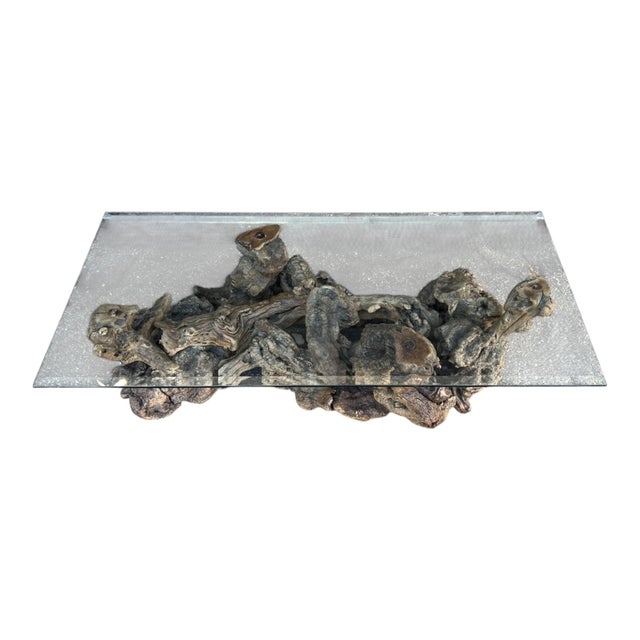 This exceptional vintage coffee table is a true statement piece, showcasing the raw beauty and sculptural elegance of...