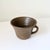A beautifully understated handcrafted studio pottery vessel with an earthy brown glaze and sculptural flared form....