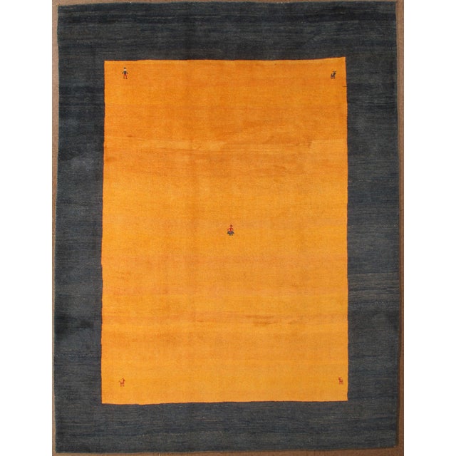 Vintage hand-knotted Persian Gabbeh rug featuring a bold, minimalist field framed by a contrasting border and accented...