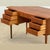 Handcrafted in Denmark during t he 1960s , this beautiful Mid-Century teak desk embodies the quiet elegance and refined...