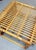 Restored rattan and pencil reed ottoman footrest featuring a top that scrolls into the side of the stool in the style of...