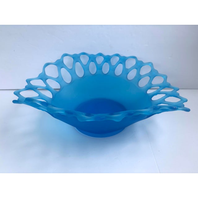 A lovely vintage Westmoreland Doric Lace oval bowl in blue satin glass, featuring a broad openwork border with alternating...