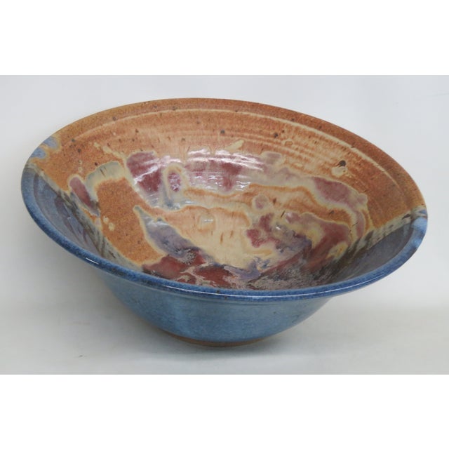 This gorgeous large bowl is made out of ceramic. It features a wide flared rim and a gorgeous glossy finish over a...