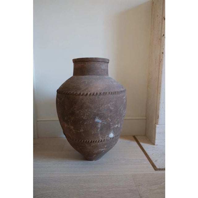 This is a large size terracotta olive jar from central Spain. It has a wonderful aged colour. It makes a great statement...