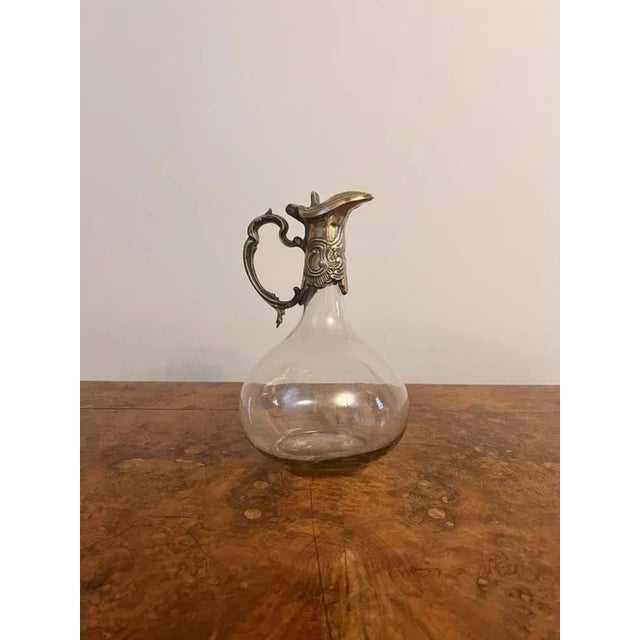 Antique art nouveau quality silver plated claret jug, having an art nouveau shaped handle, decorated lid with a lift up...