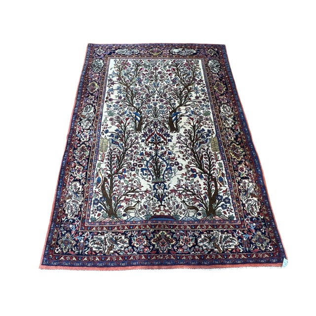 Vintage Persian Tree of Life rug, hand knotted in Iran from 100% wool. Measuring 4’7” x 6’9”, this decorative rug features...