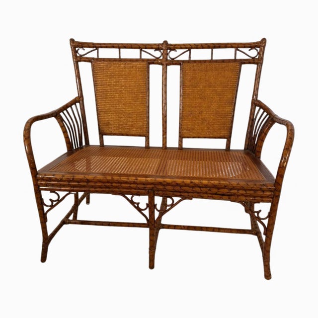 A beautifully detailed faux bamboo and cane loveseat bench that strikes the balance between refined and relaxed. The frame...