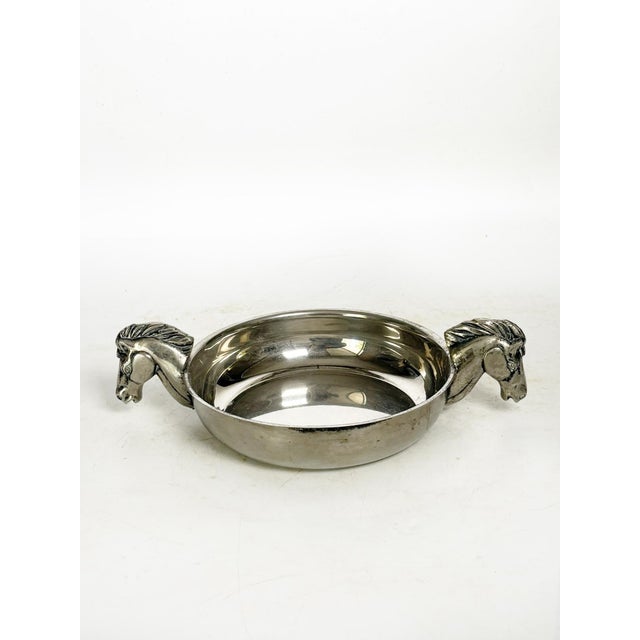 Silver-plated metal trinket dish with horse head handles, made in France in the 1970s. This elegant decorative silver-...