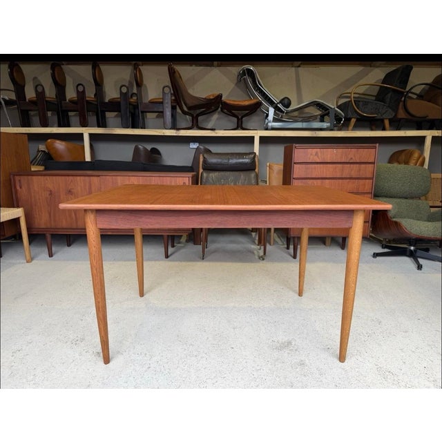 This mid-century dining table is in good used condition with age related signs of use. Stable and sound in construction,...